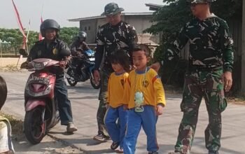 Aksi Satgas TMMD REG 129 KODIM 0726 Sukoharjo Menyeberangkan Jalan Anak tk
